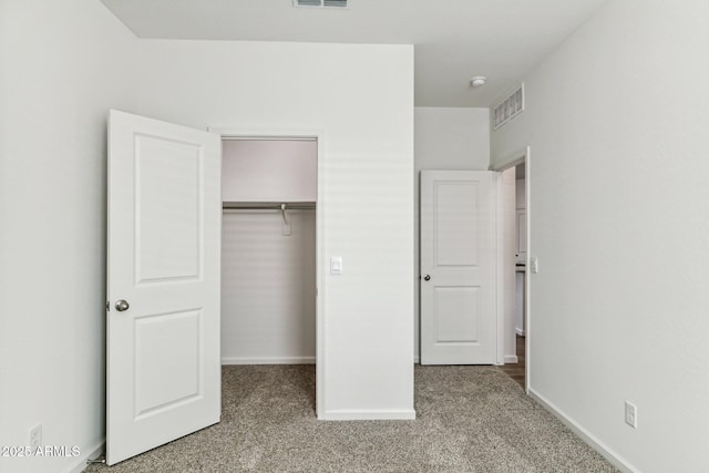 25478 W Graham Trl, Buckeye, AZ 85326 - unfurnished bedroom featuring carpet floors, a closet, baseboards, and a walk in closet