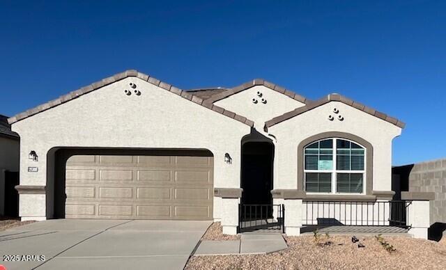 25478 W Graham Trl, Buckeye, AZ 85326 - view of front of house featuring an attached garage, stucco siding, and driveway