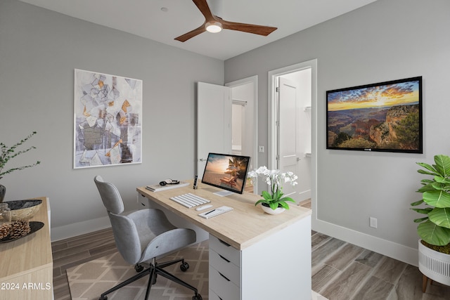 home office featuring hardwood / wood-style floors and ceiling fan