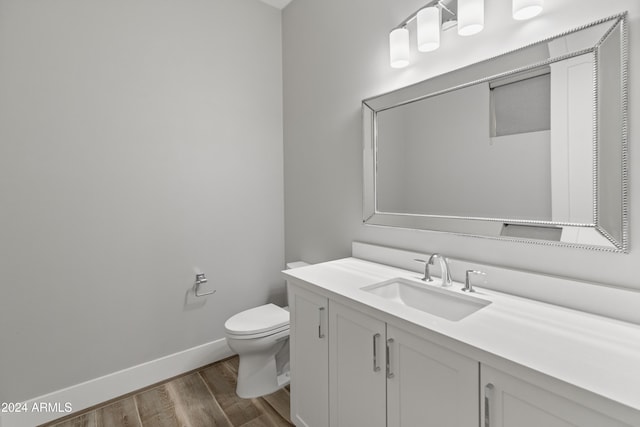 bathroom featuring vanity, toilet, and wood-type flooring