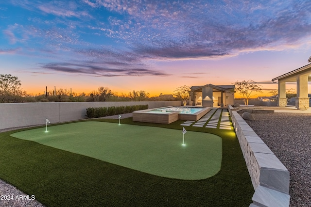 view of property's community featuring a hot tub and a patio area