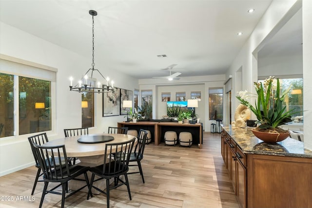 dining space with recessed lighting, visible vents, light wood-style flooring, and ceiling fan with notable chandelier