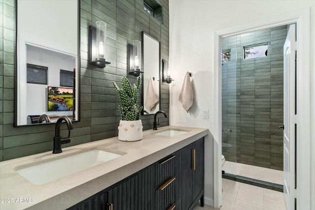 bathroom featuring a sink, backsplash, a shower stall, and tile patterned flooring