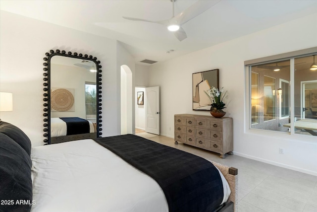 bedroom with arched walkways, visible vents, baseboards, and a ceiling fan