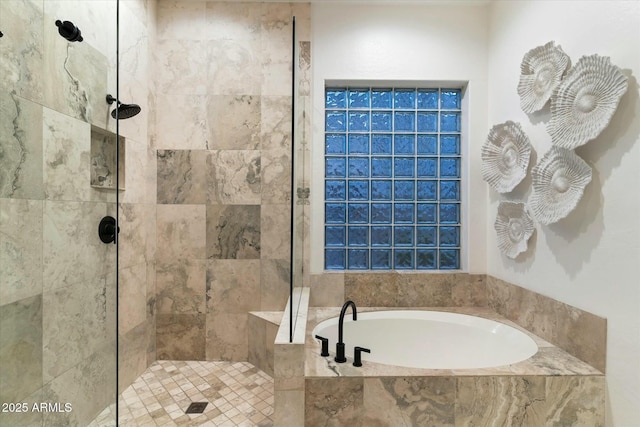 bathroom with tiled shower and a garden tub