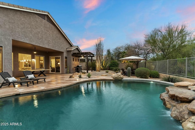 pool at dusk with a patio, fence, a fenced in pool, and ceiling fan