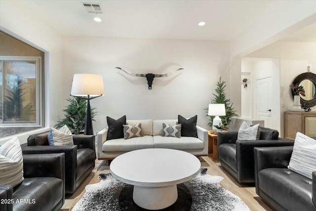 living area with recessed lighting, visible vents, and light wood-style floors