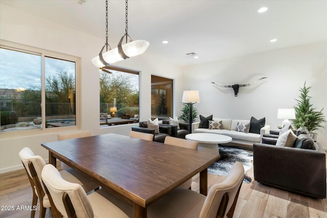 dining area with recessed lighting and light wood-style flooring