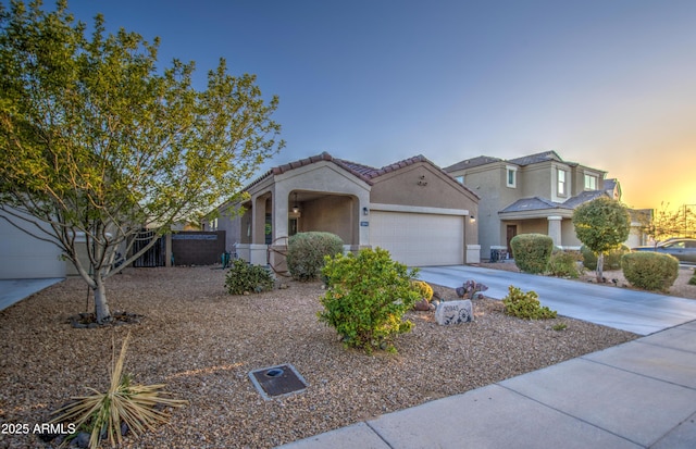 view of front of house featuring fence, an attached garage, stucco siding, concrete driveway, and a tiled roof