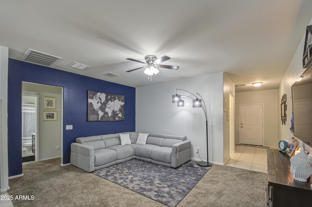 living area with visible vents and light carpet