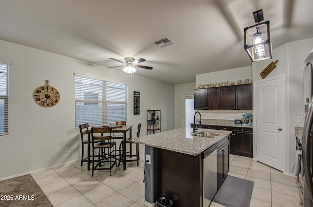 kitchen featuring dark brown cabinets, a healthy amount of sunlight, visible vents, and a sink