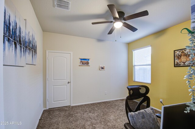 carpeted office with visible vents, baseboards, and ceiling fan