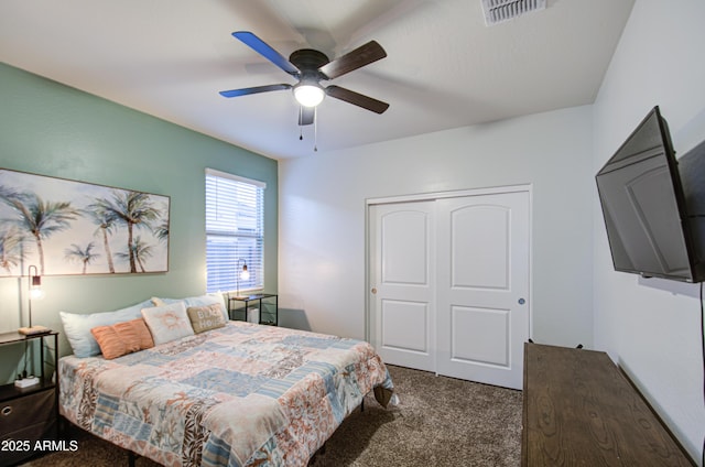 carpeted bedroom with visible vents, a closet, and ceiling fan