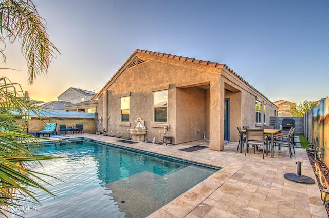 view of pool with a fenced backyard, outdoor dining space, a fenced in pool, and a patio