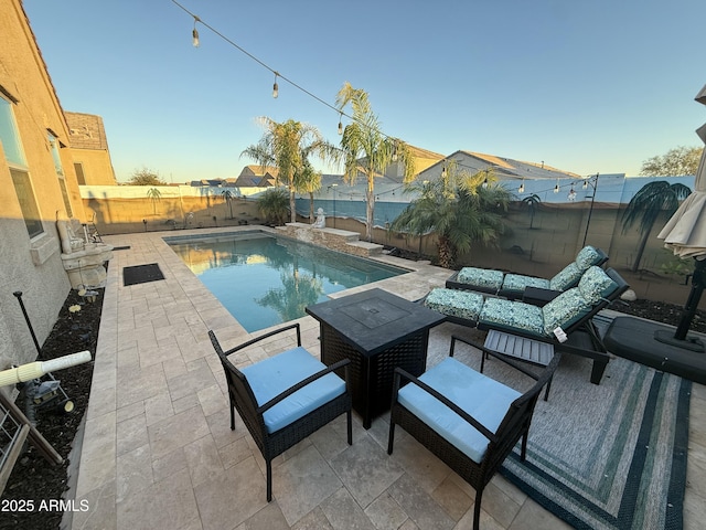 view of pool featuring outdoor lounge area, a patio, a fenced backyard, and a fenced in pool