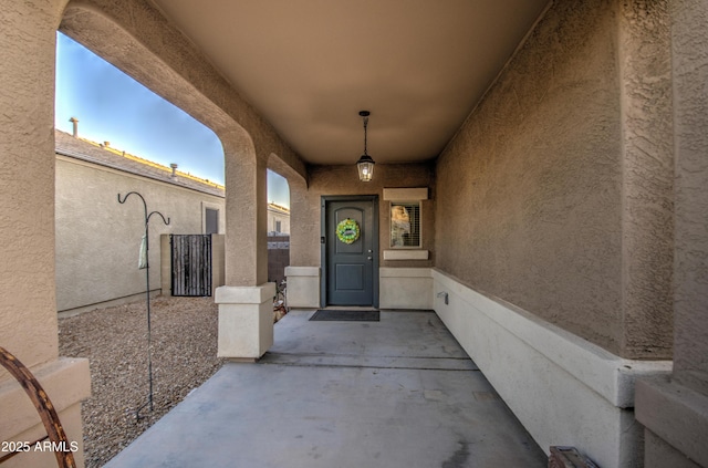 entrance to property featuring stucco siding