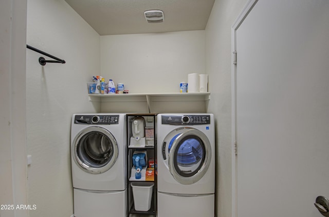 laundry area featuring laundry area, washing machine and dryer, and visible vents