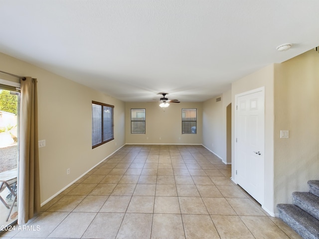 tiled empty room with ceiling fan