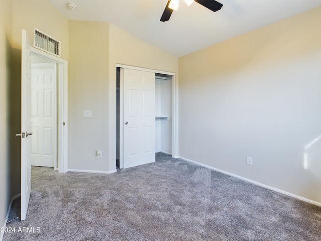 unfurnished bedroom featuring carpet flooring, ceiling fan, a closet, and lofted ceiling