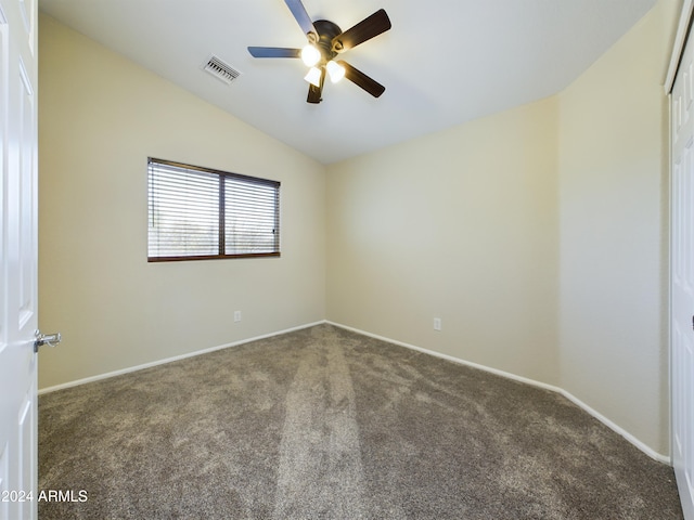 carpeted spare room featuring ceiling fan and lofted ceiling