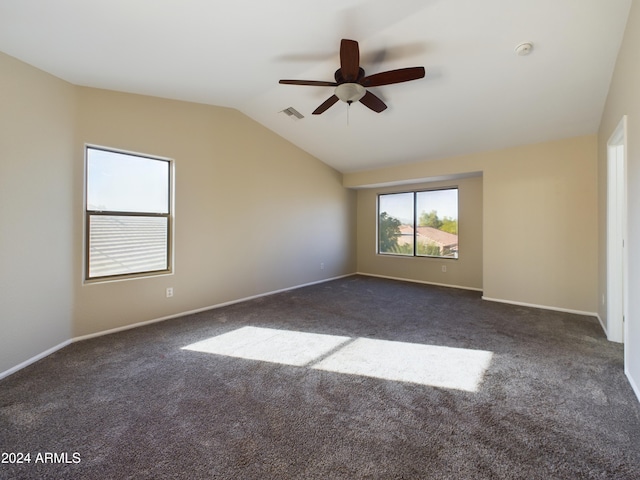 carpeted spare room featuring ceiling fan and lofted ceiling