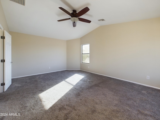 carpeted spare room with vaulted ceiling and ceiling fan