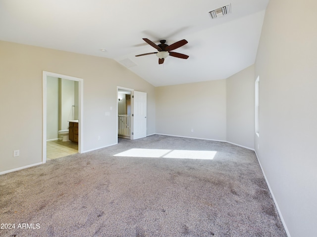 carpeted empty room featuring ceiling fan and vaulted ceiling