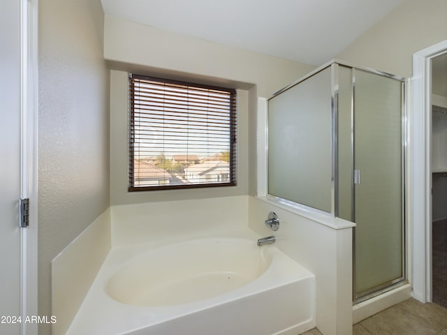 bathroom featuring independent shower and bath