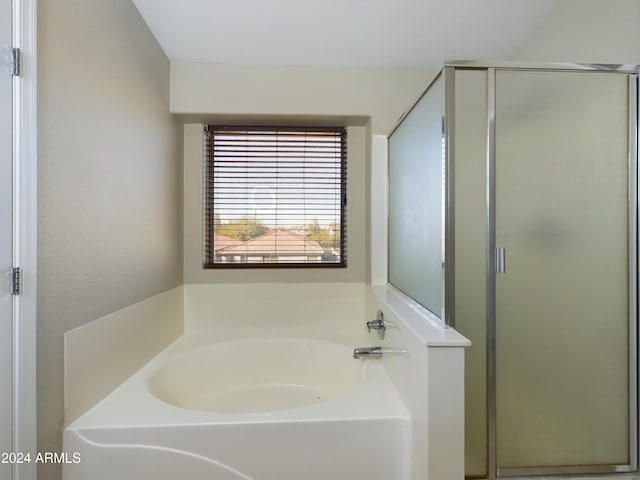 bathroom featuring separate shower and tub