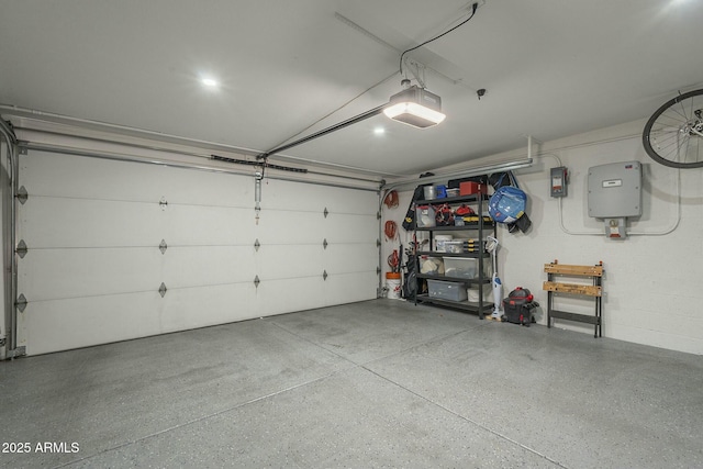 garage with a garage door opener and electric panel