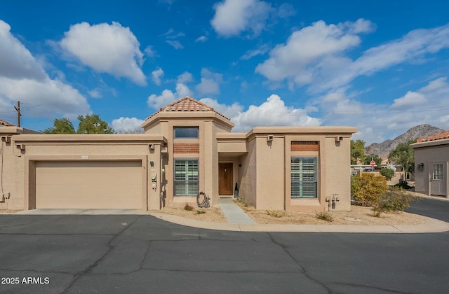 view of front of property with a mountain view and a garage