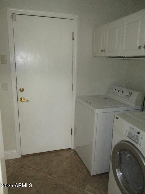 laundry room with cabinet space, independent washer and dryer, and light tile patterned floors