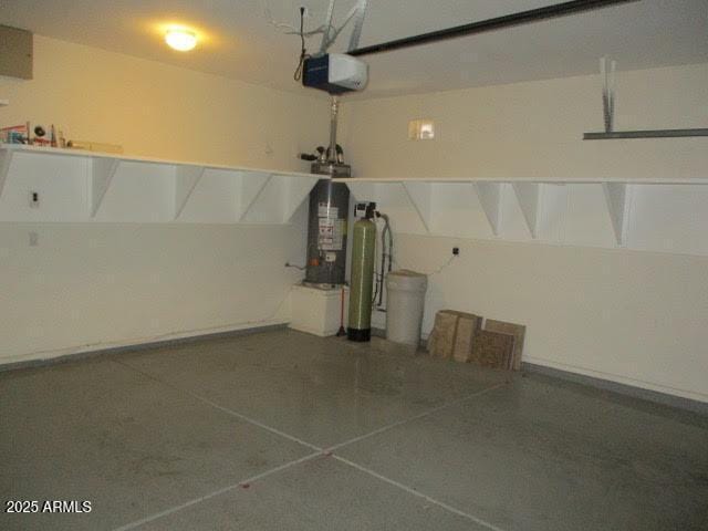 garage with water heater and a garage door opener