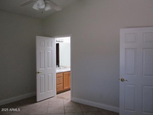 unfurnished bedroom with baseboards, ceiling fan, and light tile patterned flooring