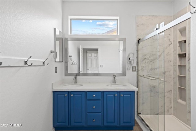 bathroom with an enclosed shower and vanity