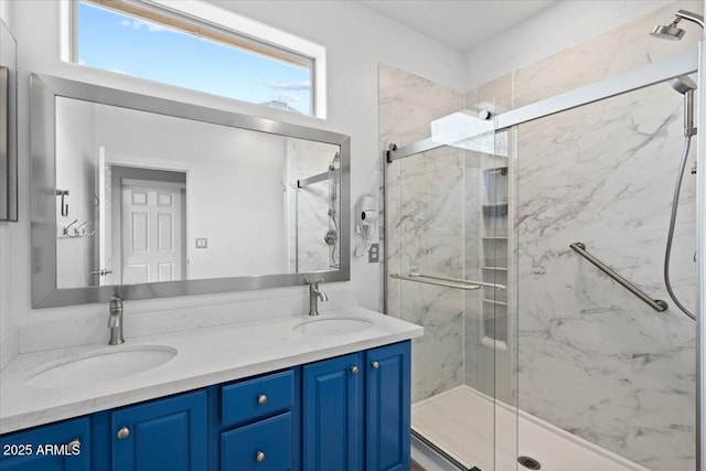 bathroom featuring vanity and a shower with door