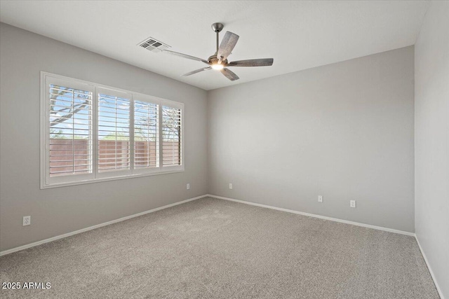 empty room featuring carpet floors and ceiling fan