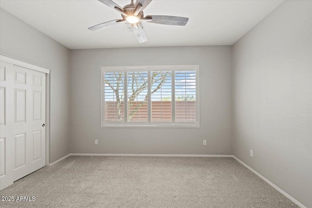 unfurnished bedroom with ceiling fan, carpet, and a closet