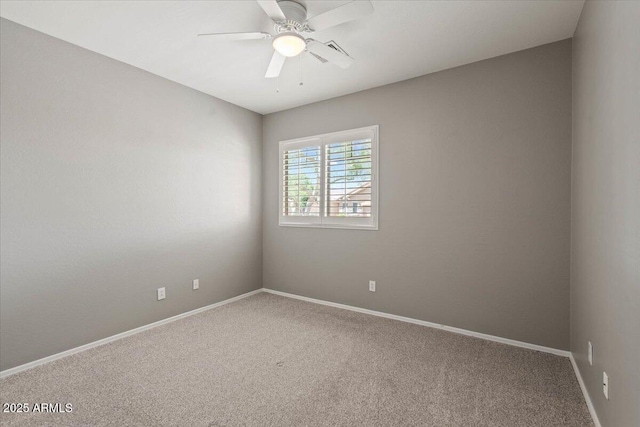 carpeted spare room featuring ceiling fan