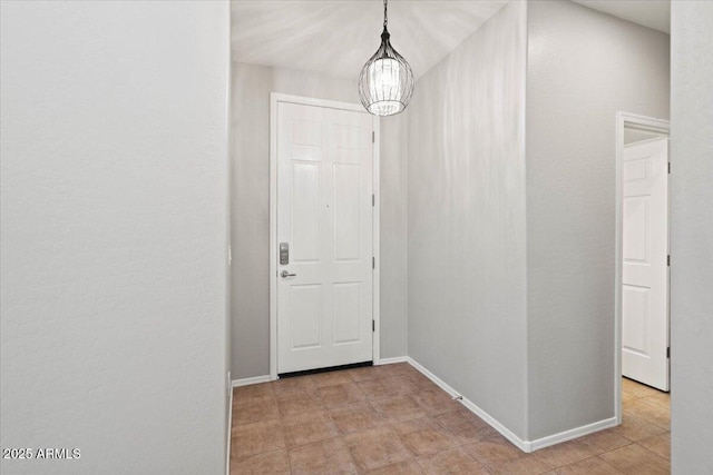 doorway to outside with a chandelier