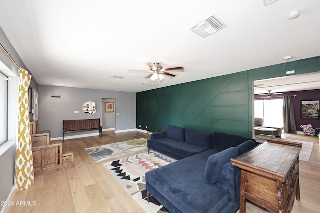 living room with ceiling fan and wood-type flooring