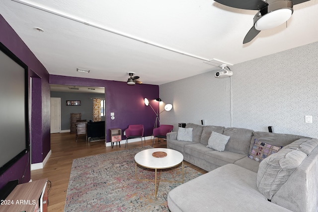 living room with hardwood / wood-style floors and ceiling fan