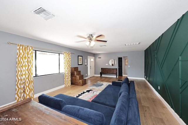 living room featuring light wood-type flooring and ceiling fan