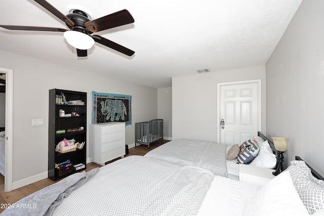 bedroom with hardwood / wood-style flooring and ceiling fan