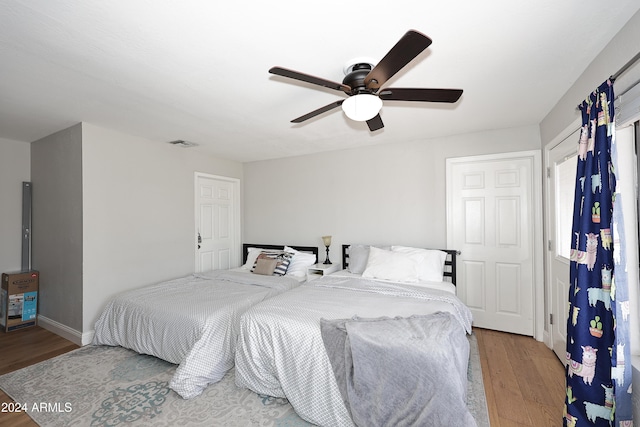 bedroom featuring light wood-type flooring and ceiling fan