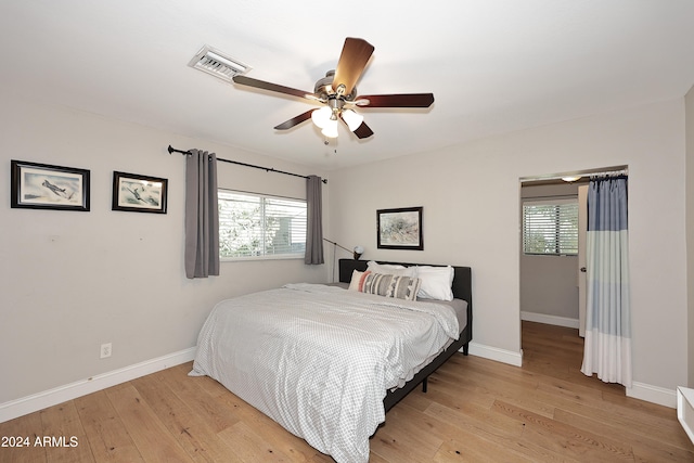 bedroom featuring multiple windows, ceiling fan, and light hardwood / wood-style floors