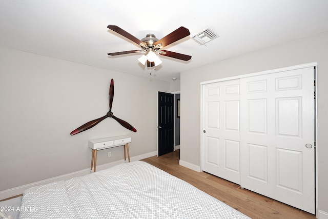 bedroom featuring a closet, ceiling fan, and light hardwood / wood-style flooring