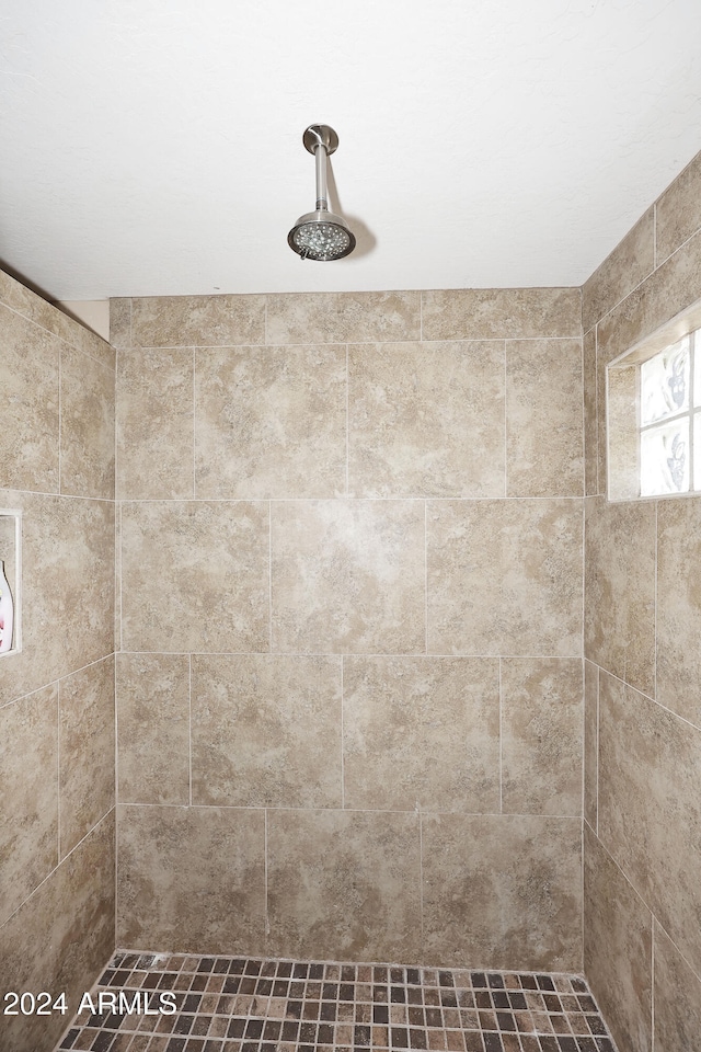 bathroom with tiled shower