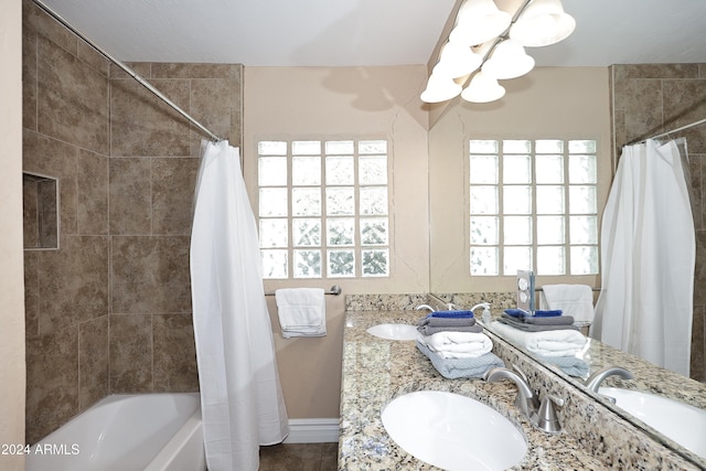 bathroom featuring shower / tub combo, vanity, and plenty of natural light