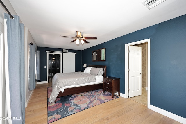 bedroom with ceiling fan and light hardwood / wood-style floors